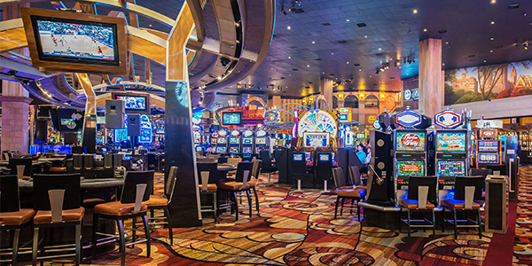 modern casino game room with tables and slot machines