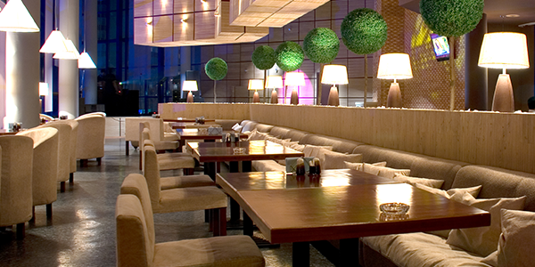 Modern hotel dining area with tables and booths